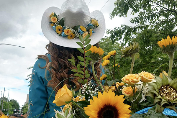 For floral hatbands, flowers are placed on the back side of hats for best display.