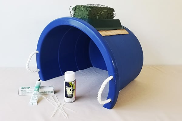 a large plastic bucket to replicate the rear-end of the horse and allow you to design in floral foam wired to a casket saddle.