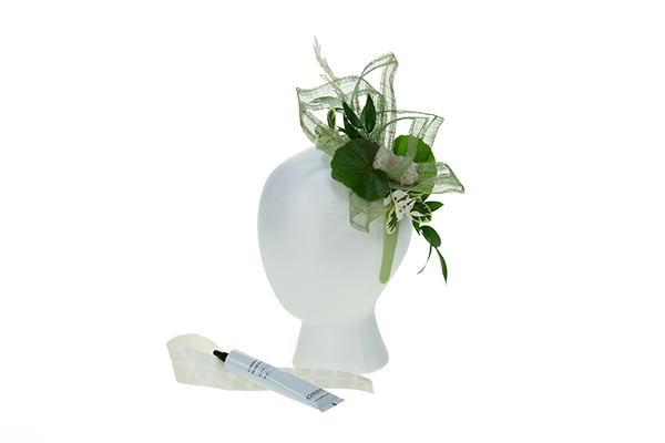 Add various foliages, both fresh and preserved, to create a mix of colors and textures for the floral fascinator.