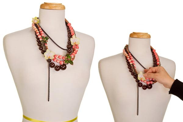 Adding flowers to the bundle of necklaces.