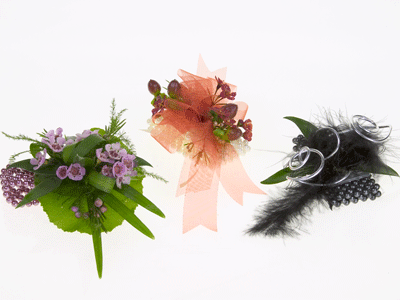 Enhance each corsage base with fluffy feathers and filler foliage like waxflower or hypericum berries.