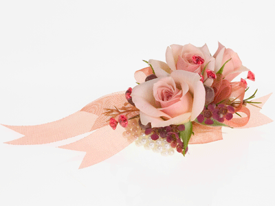 Create a romantic corsage by mixing spray roses and waxflower with ribbon and diamante pins for a sweetheart style.