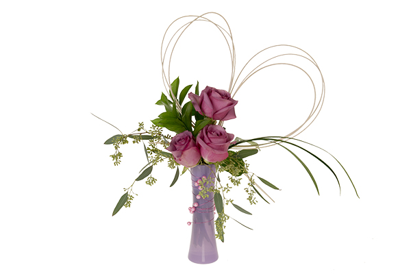 A beautiful Valentine's Day budvase is filled with pink roses, seeded eucalyptus, Israeli ruscus, hearts made from midollino sticks, and a few pearls for elegance.