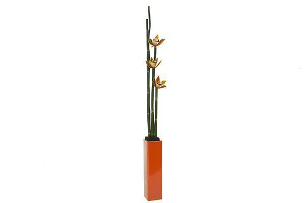 The orchids’ shade of orange pulls color from the top of the design to the bottom of the vase.