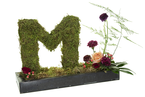 Add beautiful blooms and foliage to base of this lovely moss-covered monogram for a finishing touch.