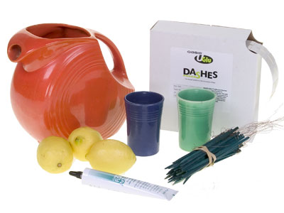 Materials for this design include a Fiestaware pitcher and glasses, lemons, wood picks, UGlu dashes, cold glue, roses, feverfew, veronica, ruscus, plumosa, and salal.
