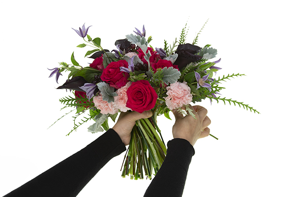 Adding final blossoms to the nearly finished bouquet