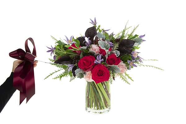 Adding a ribbon bow to the bouquet