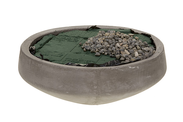Line the concrete container, fill it with floral foam, and cover part of it with pea gravel.