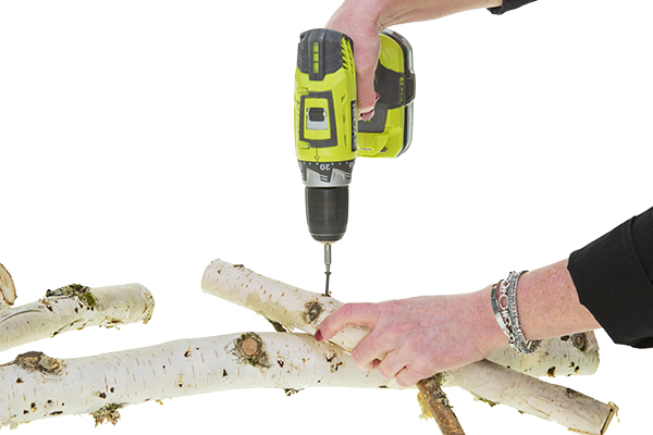 using the electric drill to screw branches together