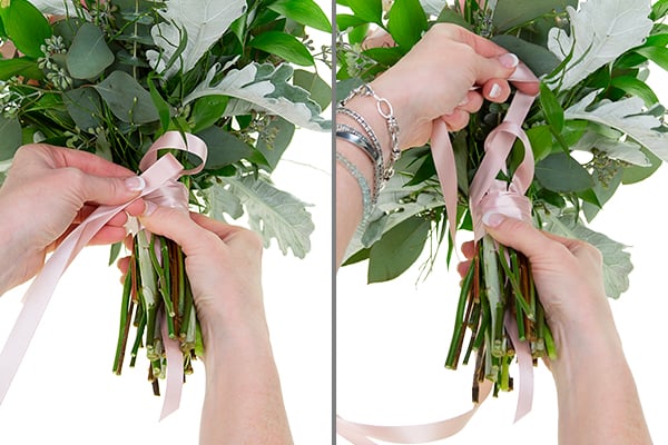 Feeding the ribbon through the loop at the base of the bouquet. 