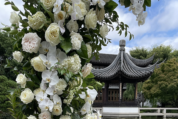 A column of garden flowers in from of a pagoda at the LanSu Garden.