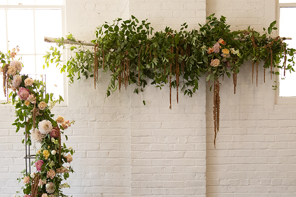 The urban studio wedding featuring a flower cloud and arch.