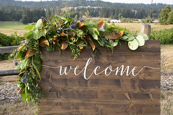 Vinyard welcome sign decorated with flowers.