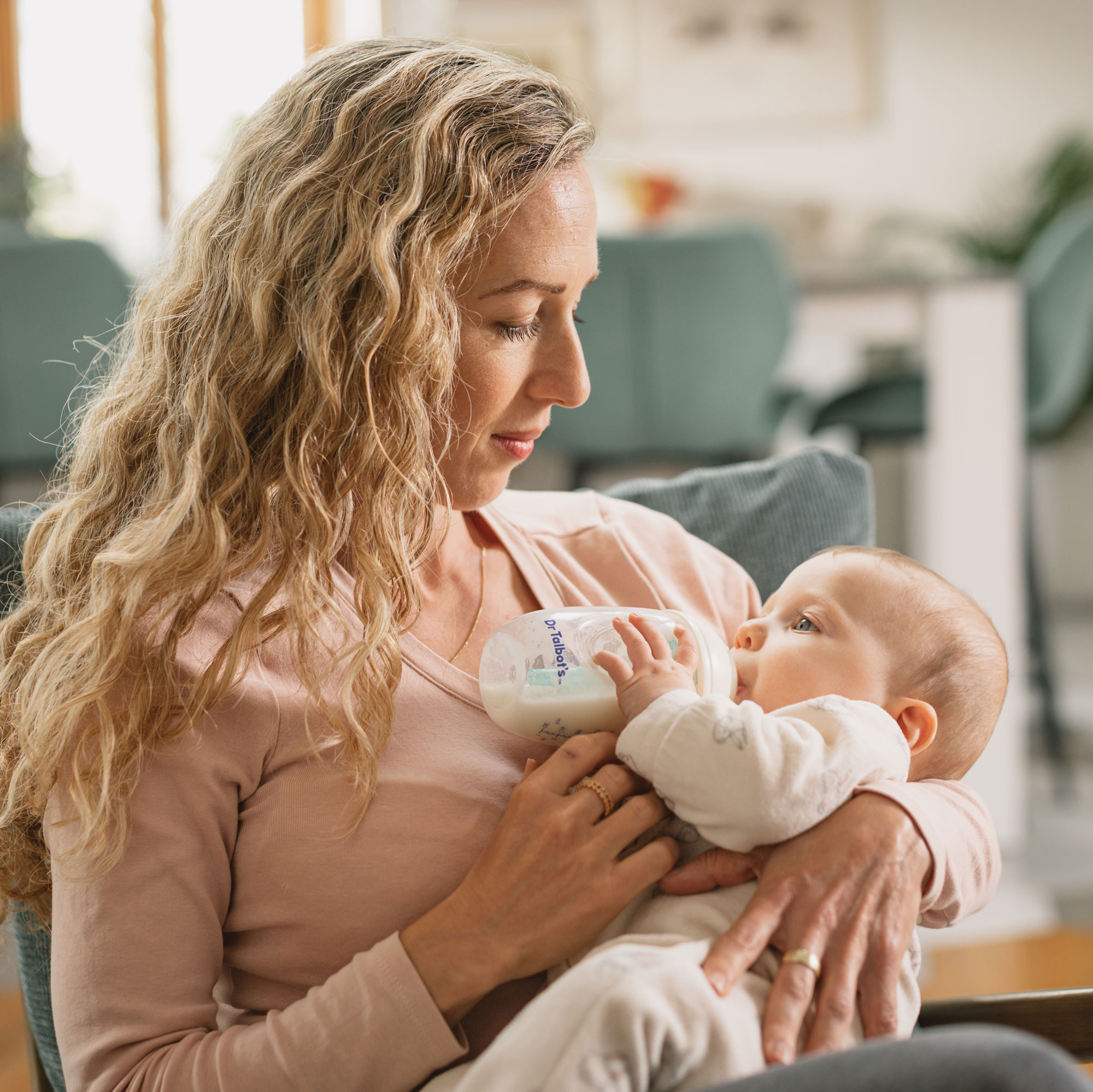 mommy bottle feeding a baby