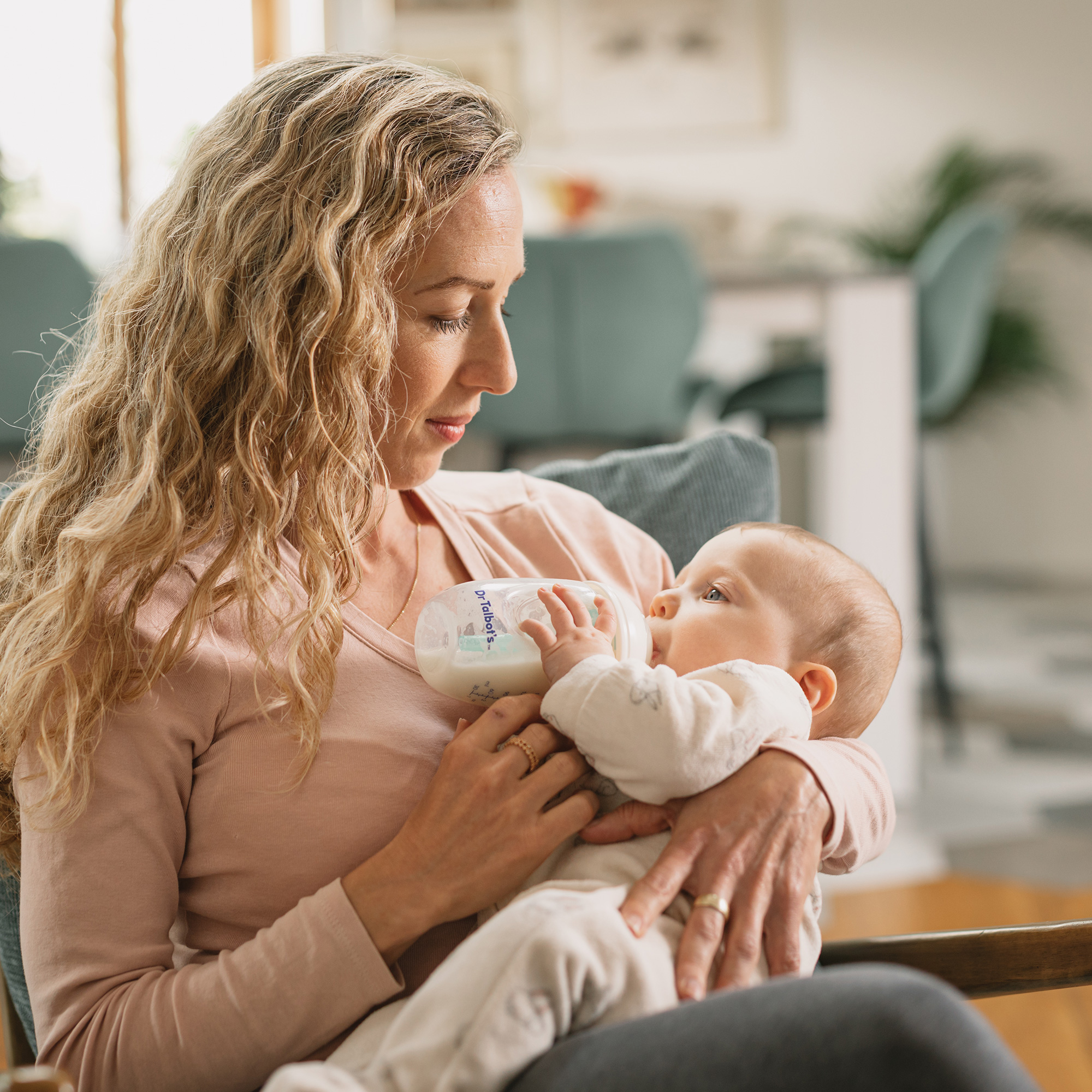 mommy bottle feeding a baby