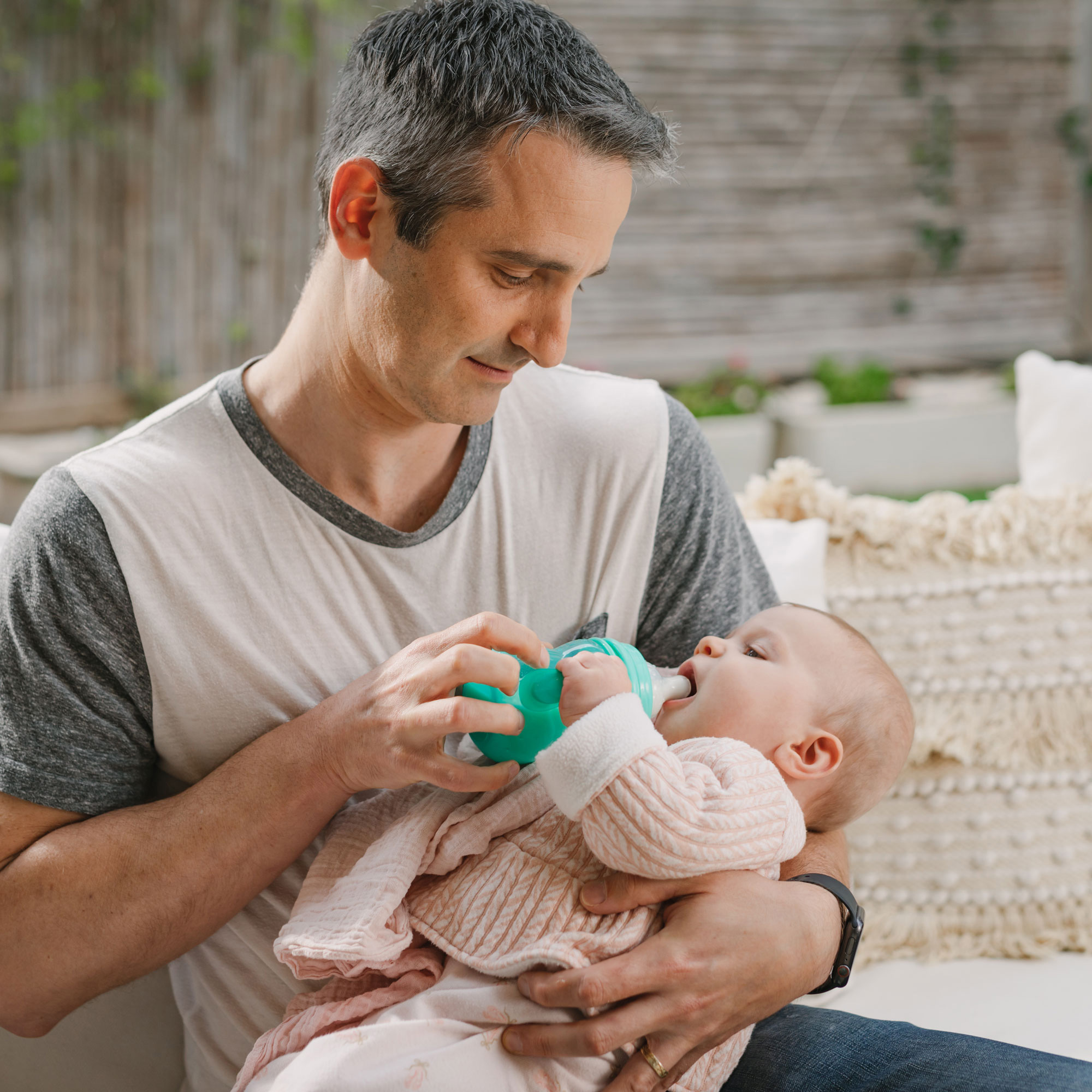 dad bottle feeding a baby