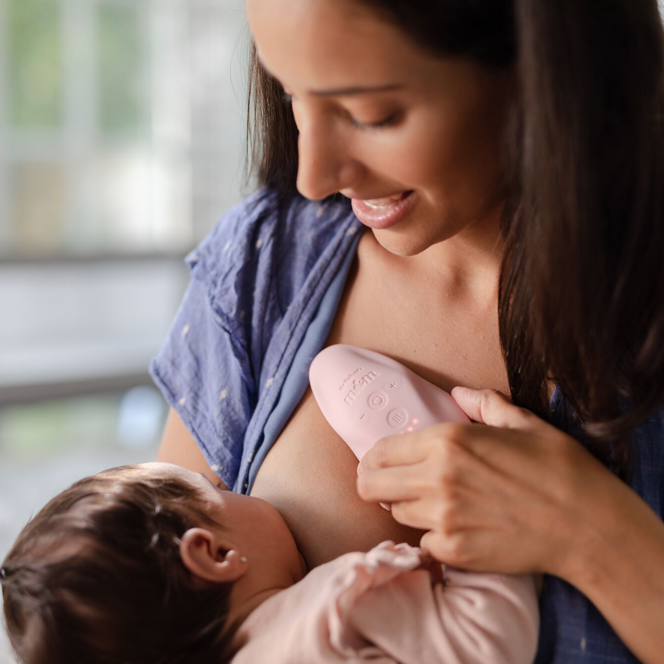 mom breastfeeding baby in bedroom