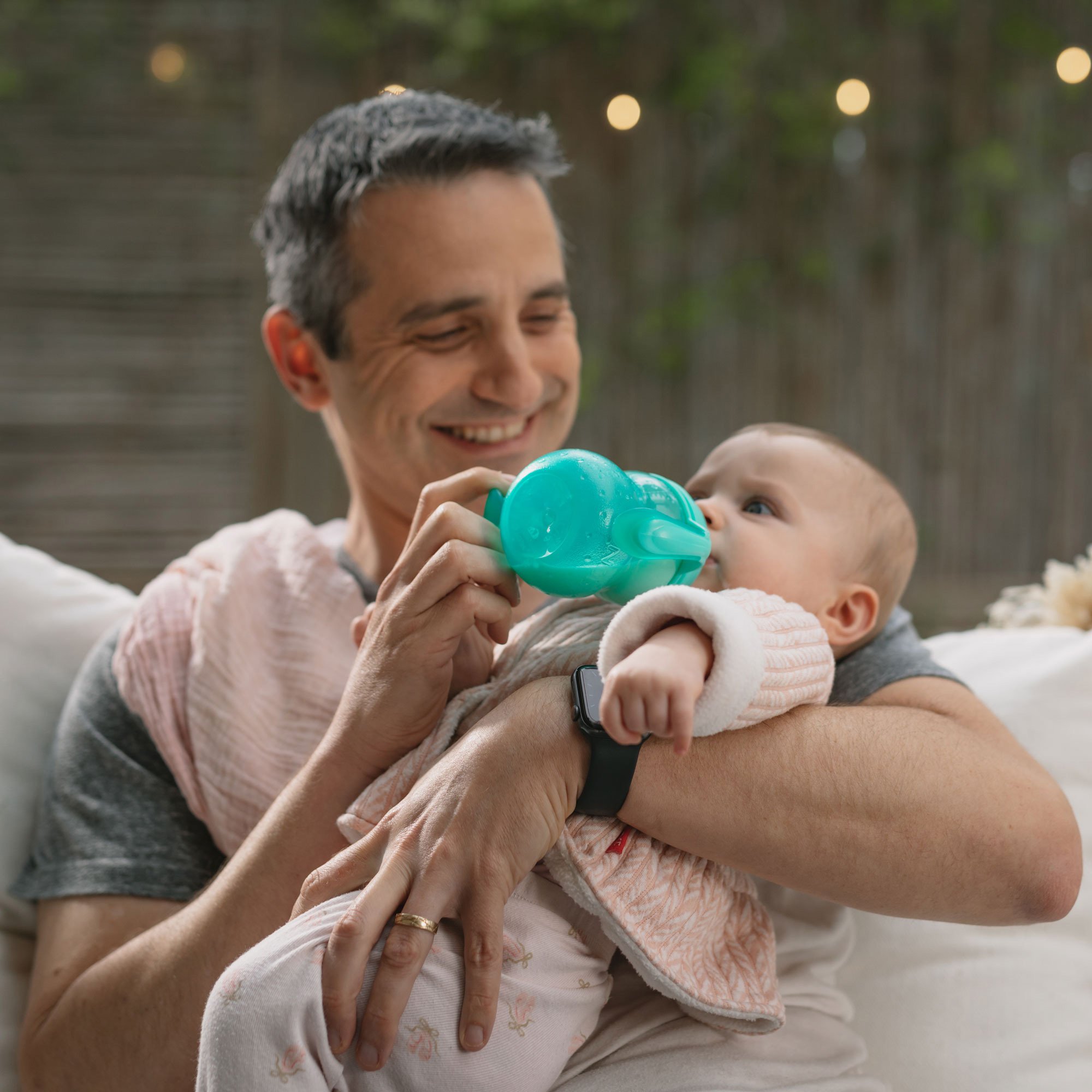 Dad bottle feeding baby