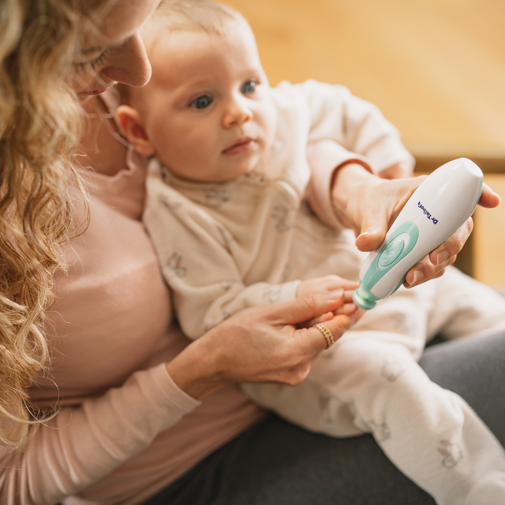 Mom filing baby's nails