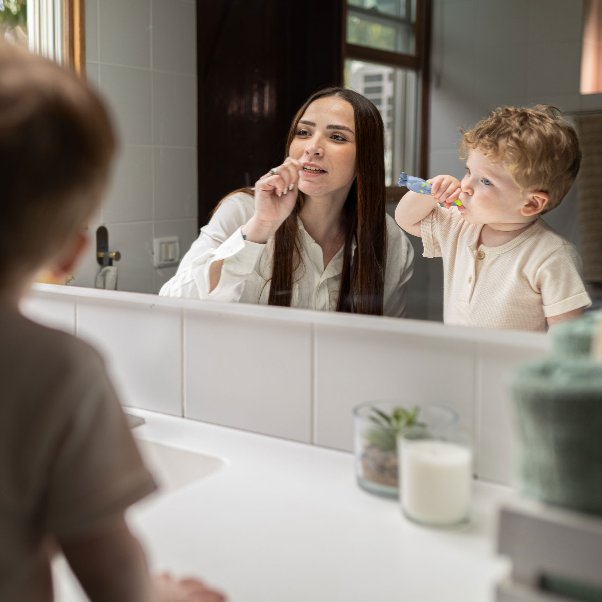 mom teaching kid how to brush