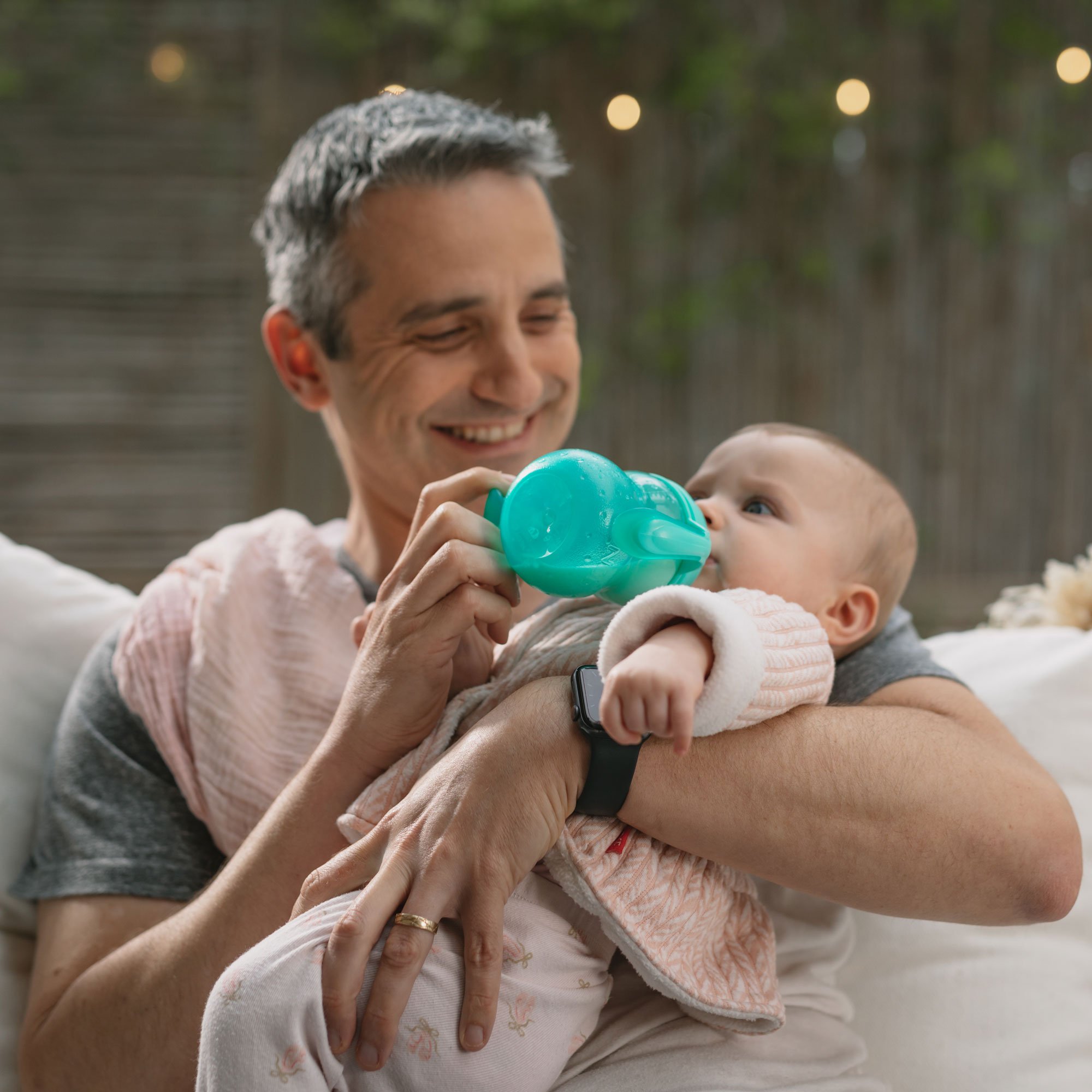 father bottle feeding baby