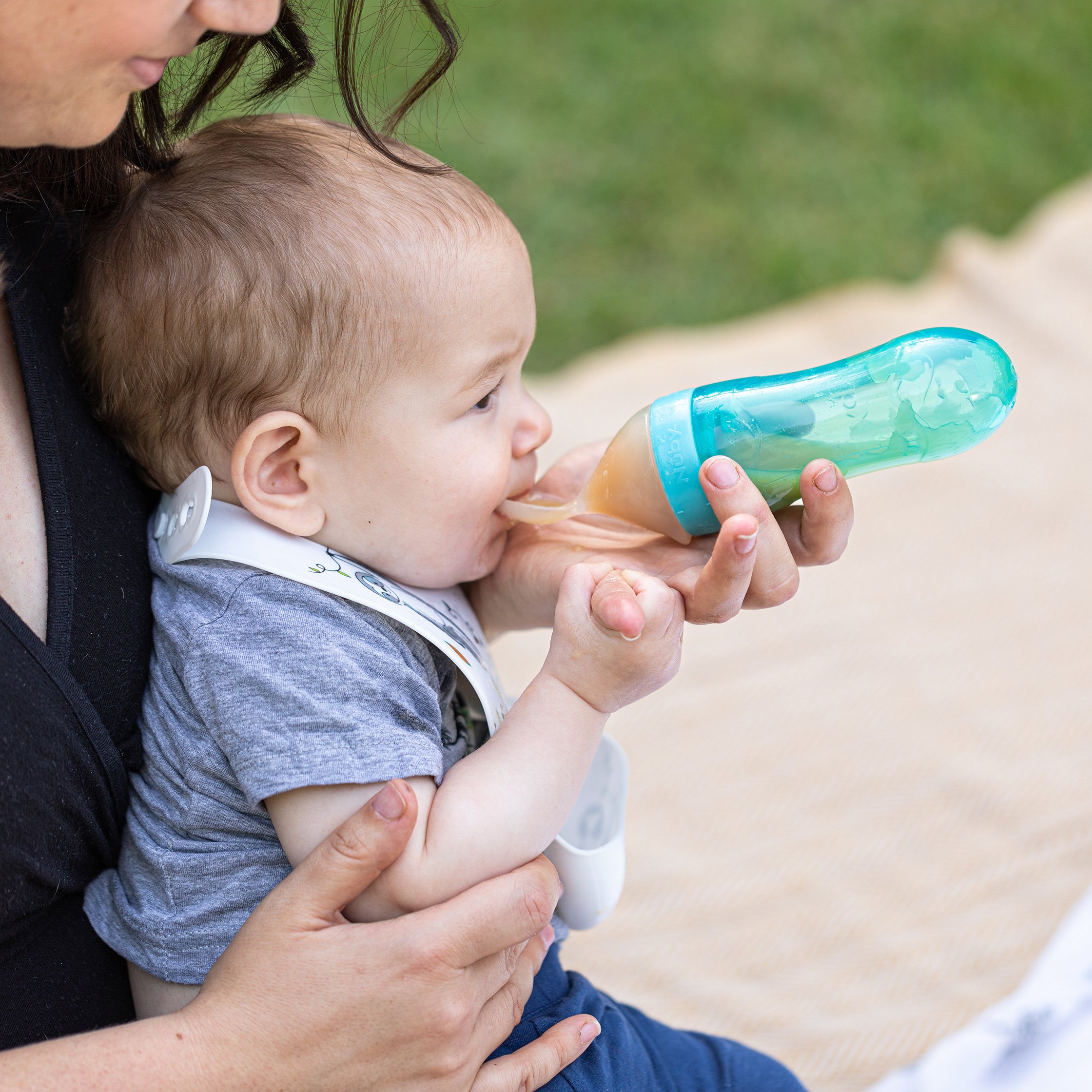 mom feeding baby soft food