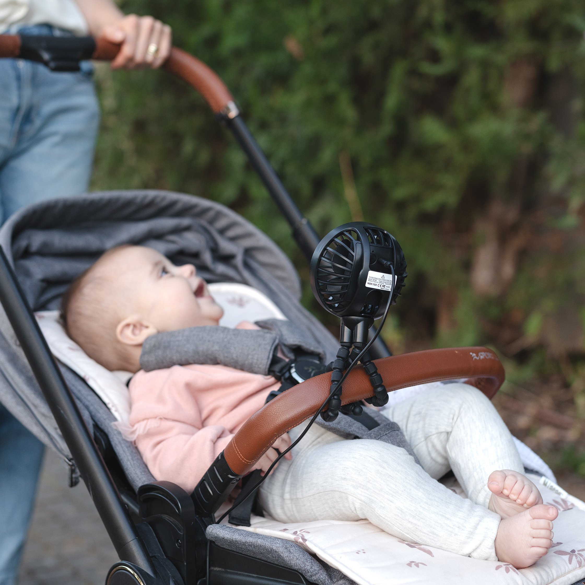 baby in stroller with fan