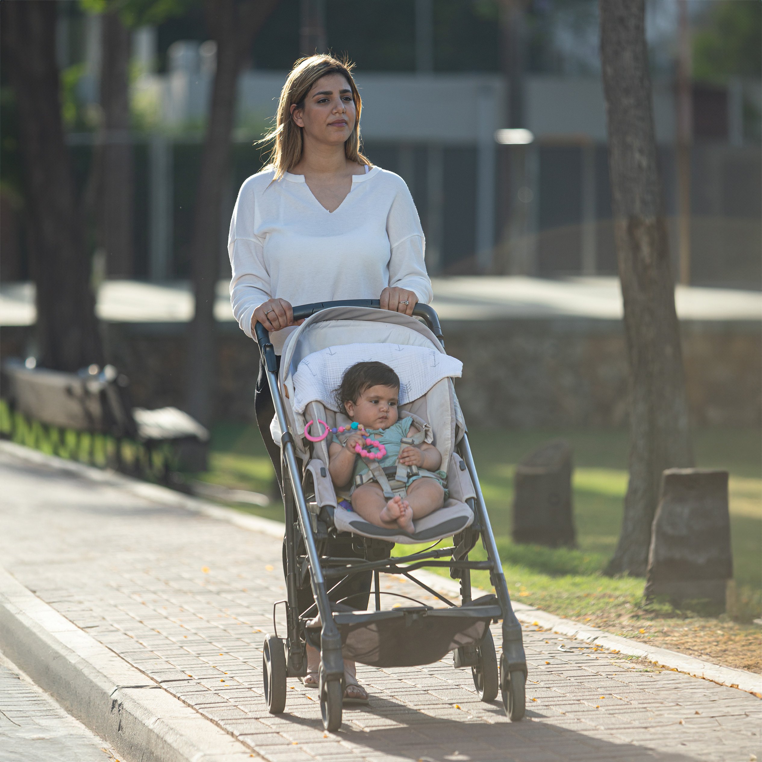 mom strolling with baby