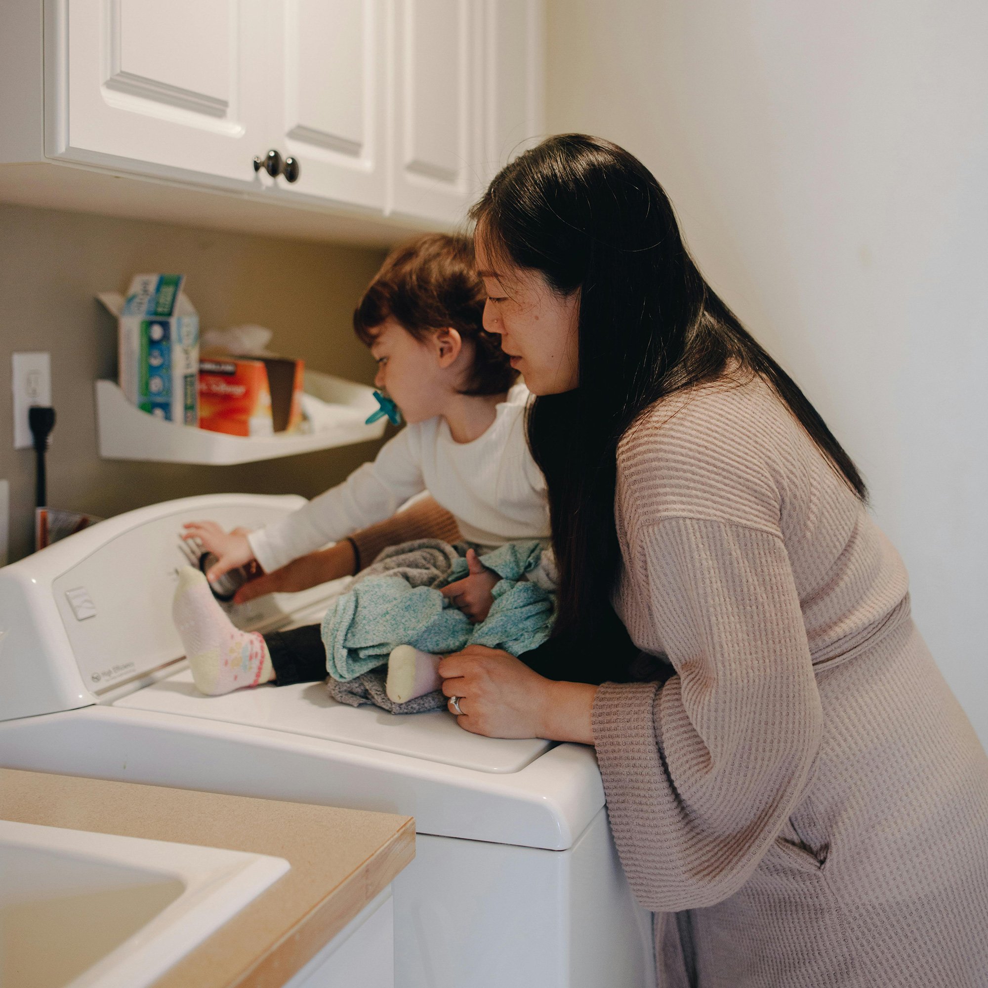 mom and baby doing laundry