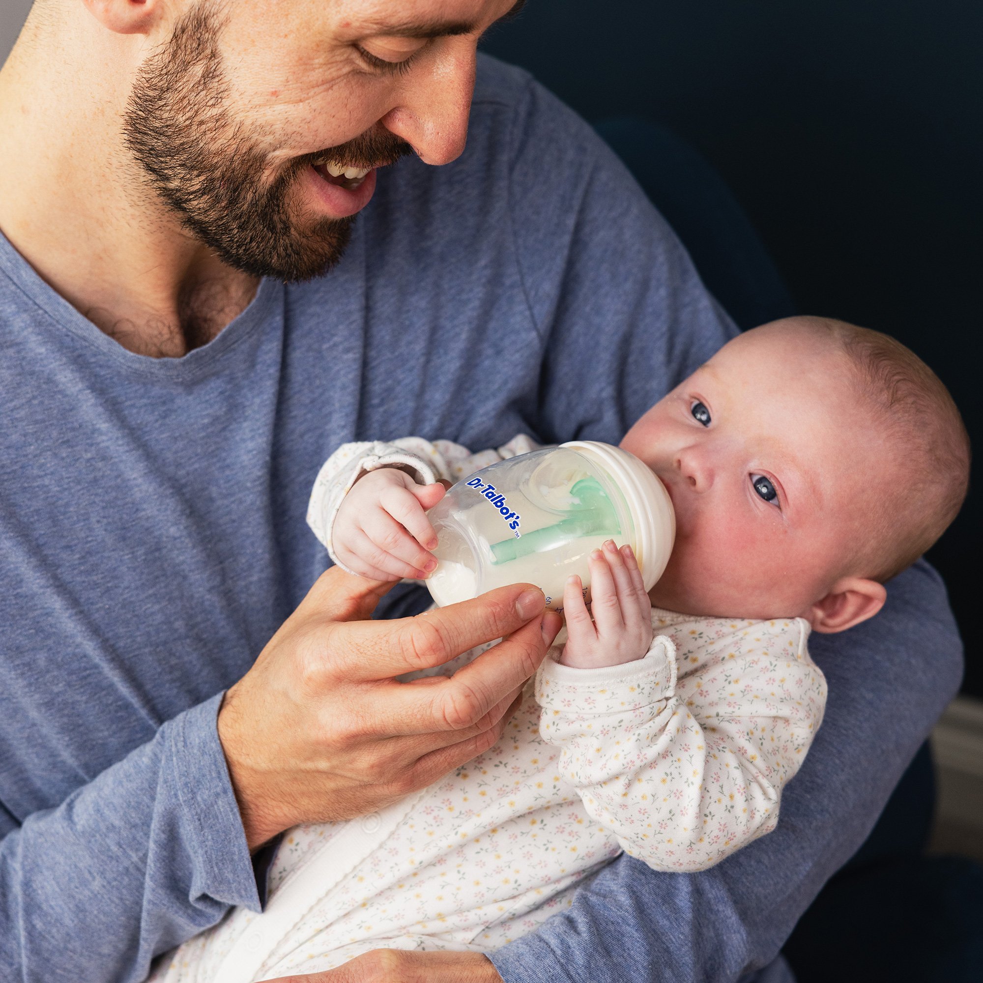 dad bottle feeding baby