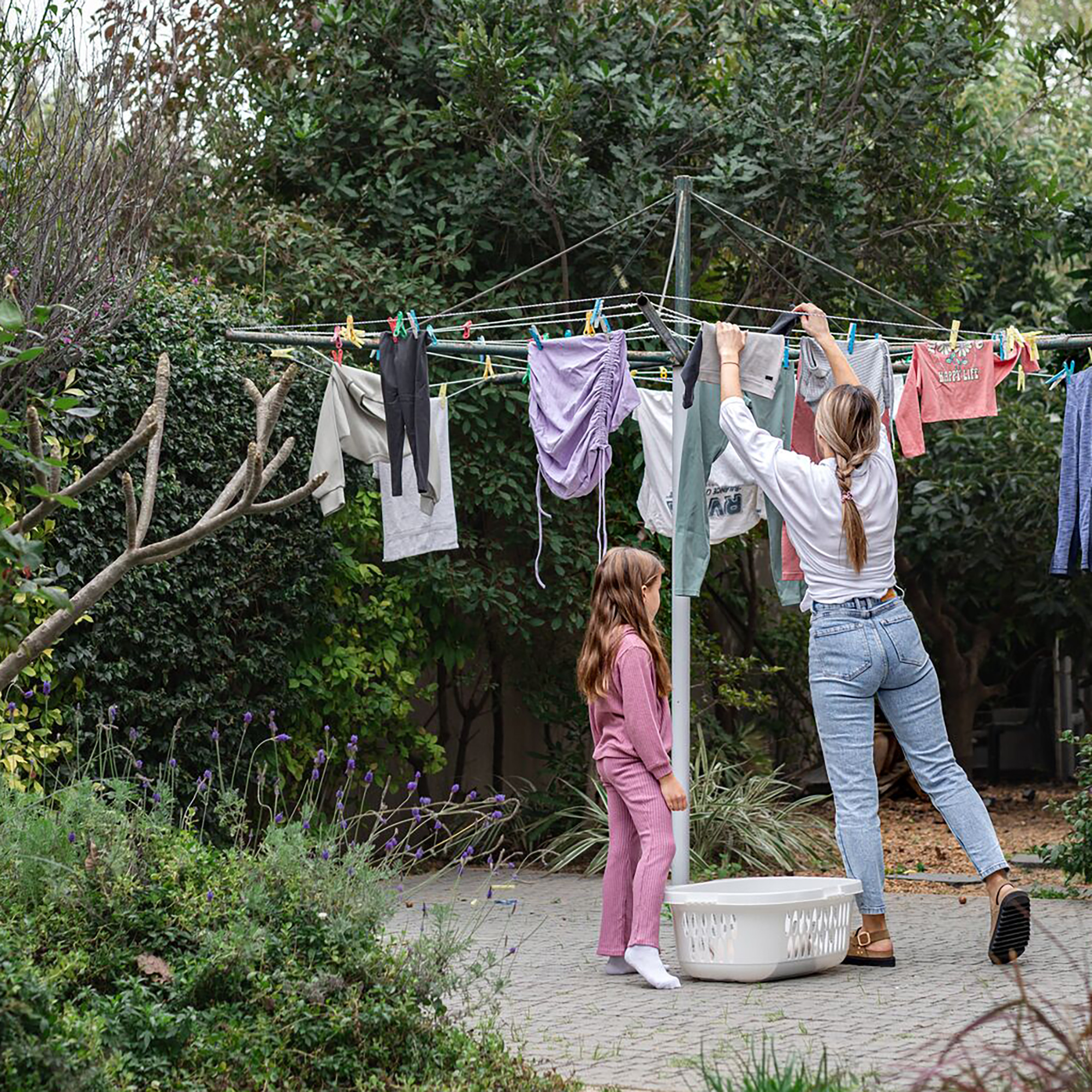 mom and daughter hanging laundry