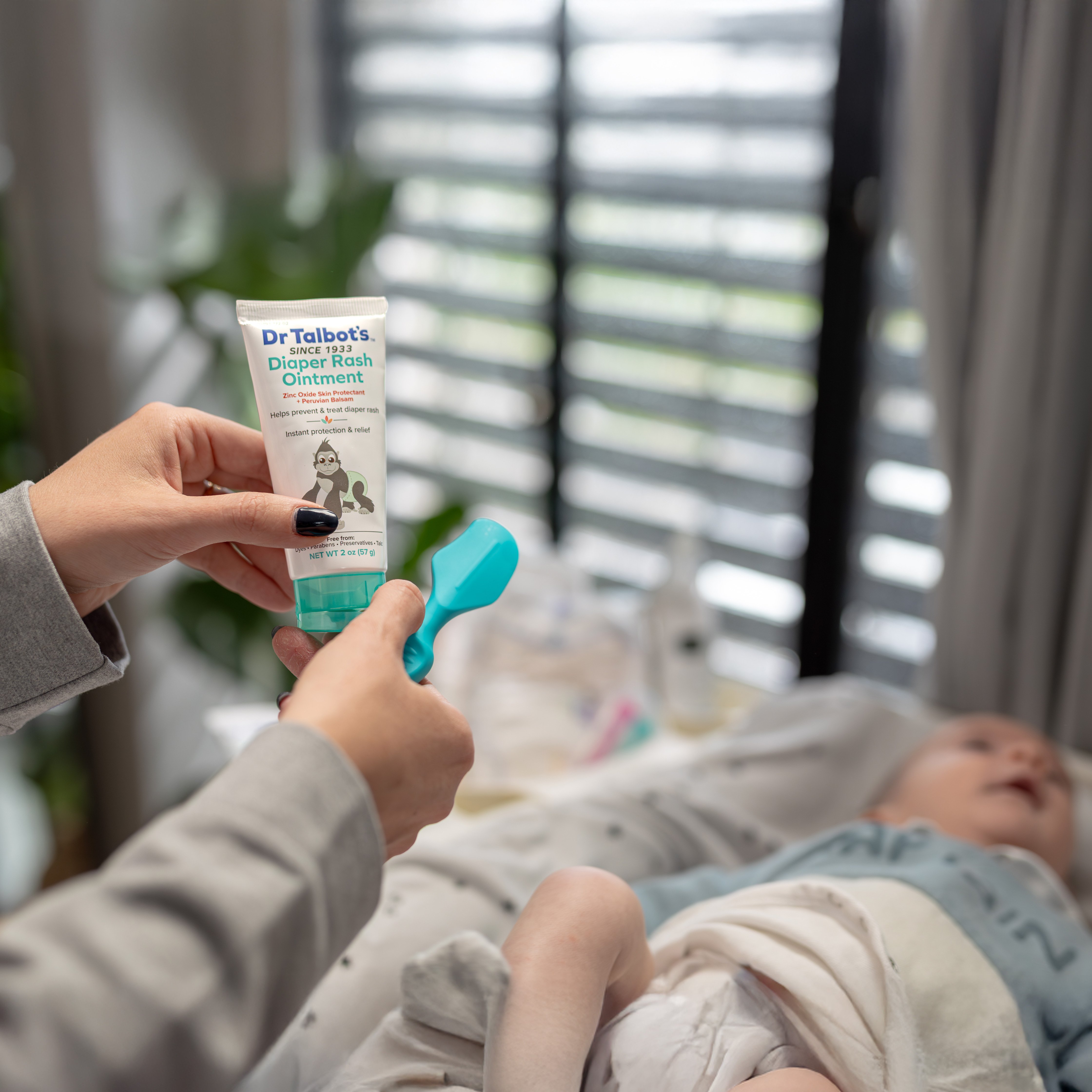 Applying diaper rash ointment on brush