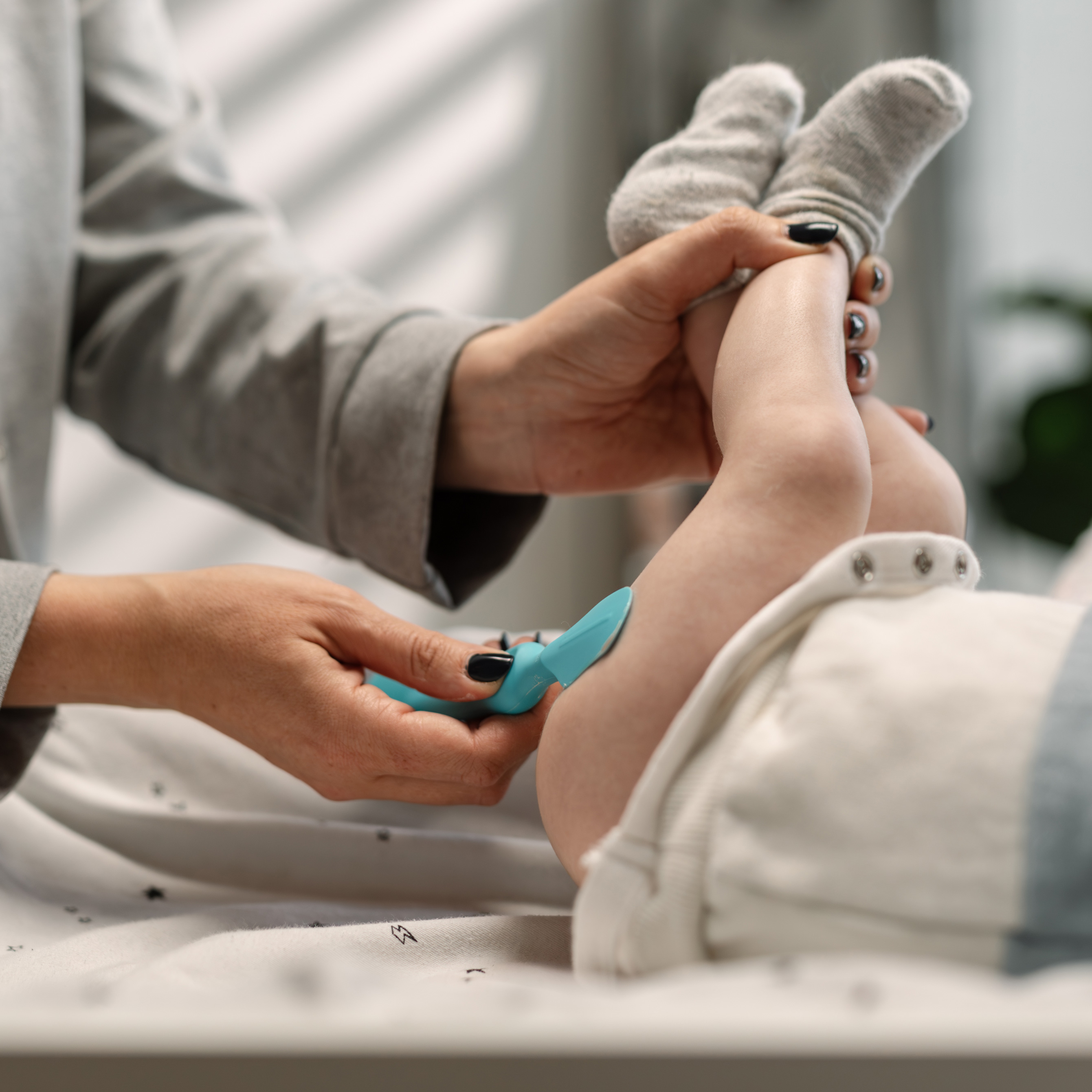 Mom applying diaper rash ointment on baby