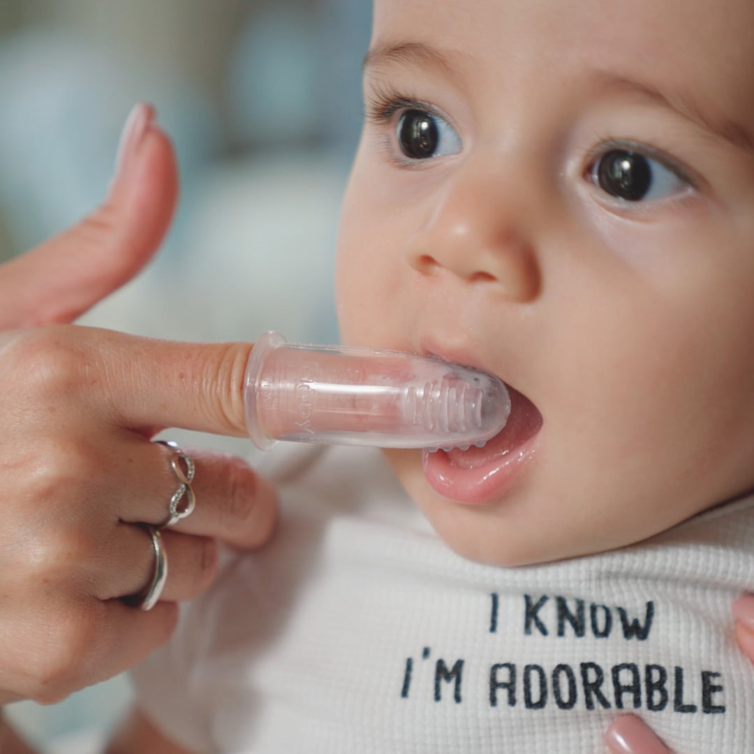 applying tooth gel to baby