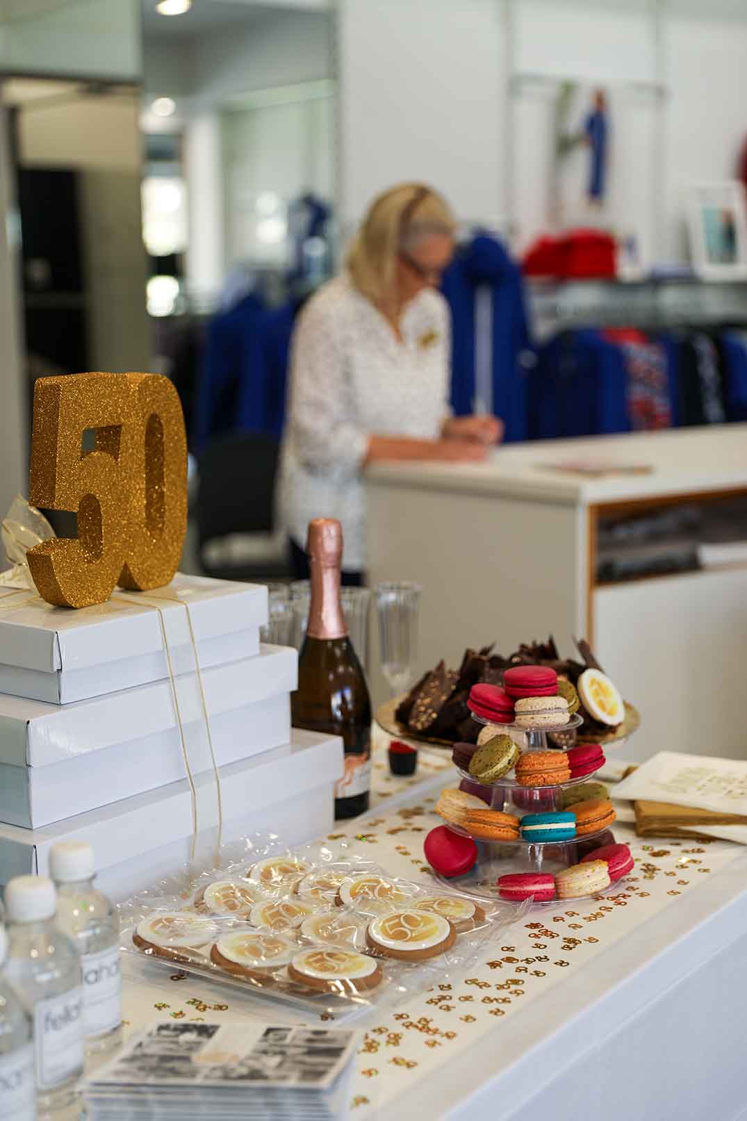 Close up shot of the celebrations at Fella Hamilton's 50th Anniversary, featuring biscuits, macaroons and champagne. 