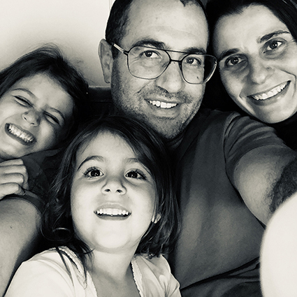 Photo of Isabel and her husband and two daughters.