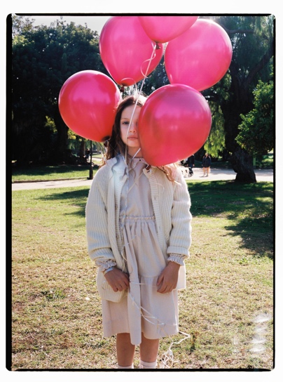 A person holding a bunch of balloons

Description automatically generated with medium confidence