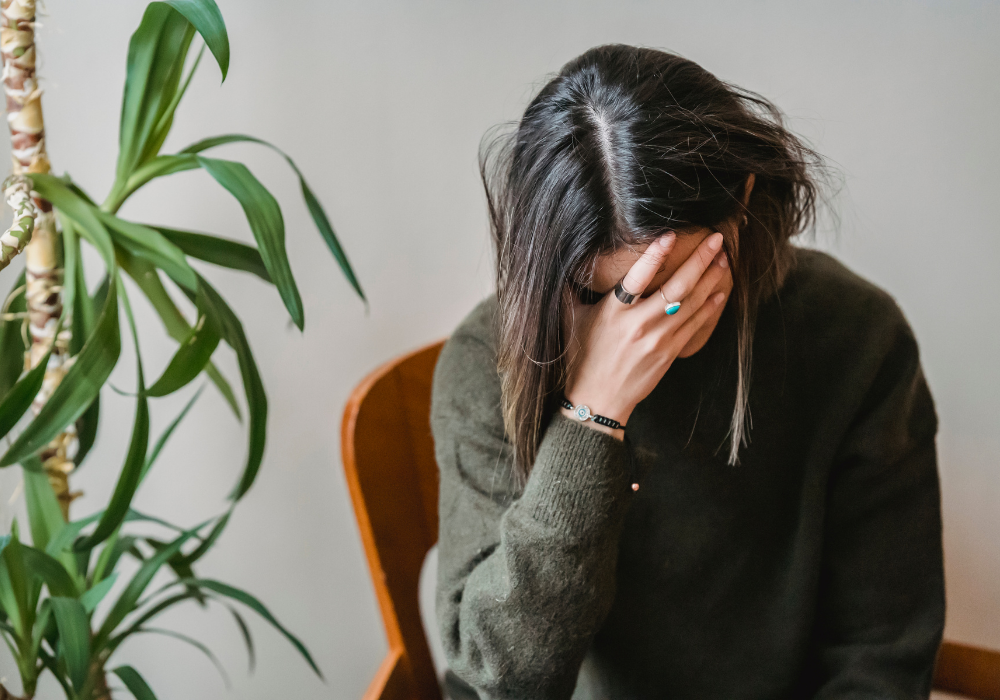 Women holding head with Fatigue