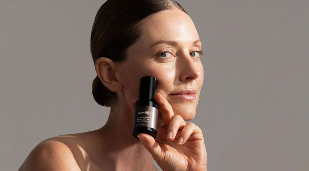 Skincare model using SuperSerum+ by Synergie Skin