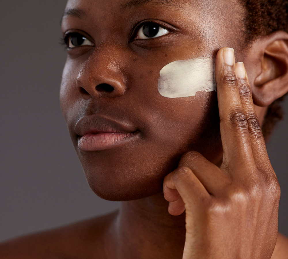 Women applying face moisturiser