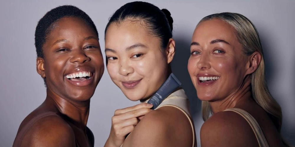 Three Synergie Skin models smiling.