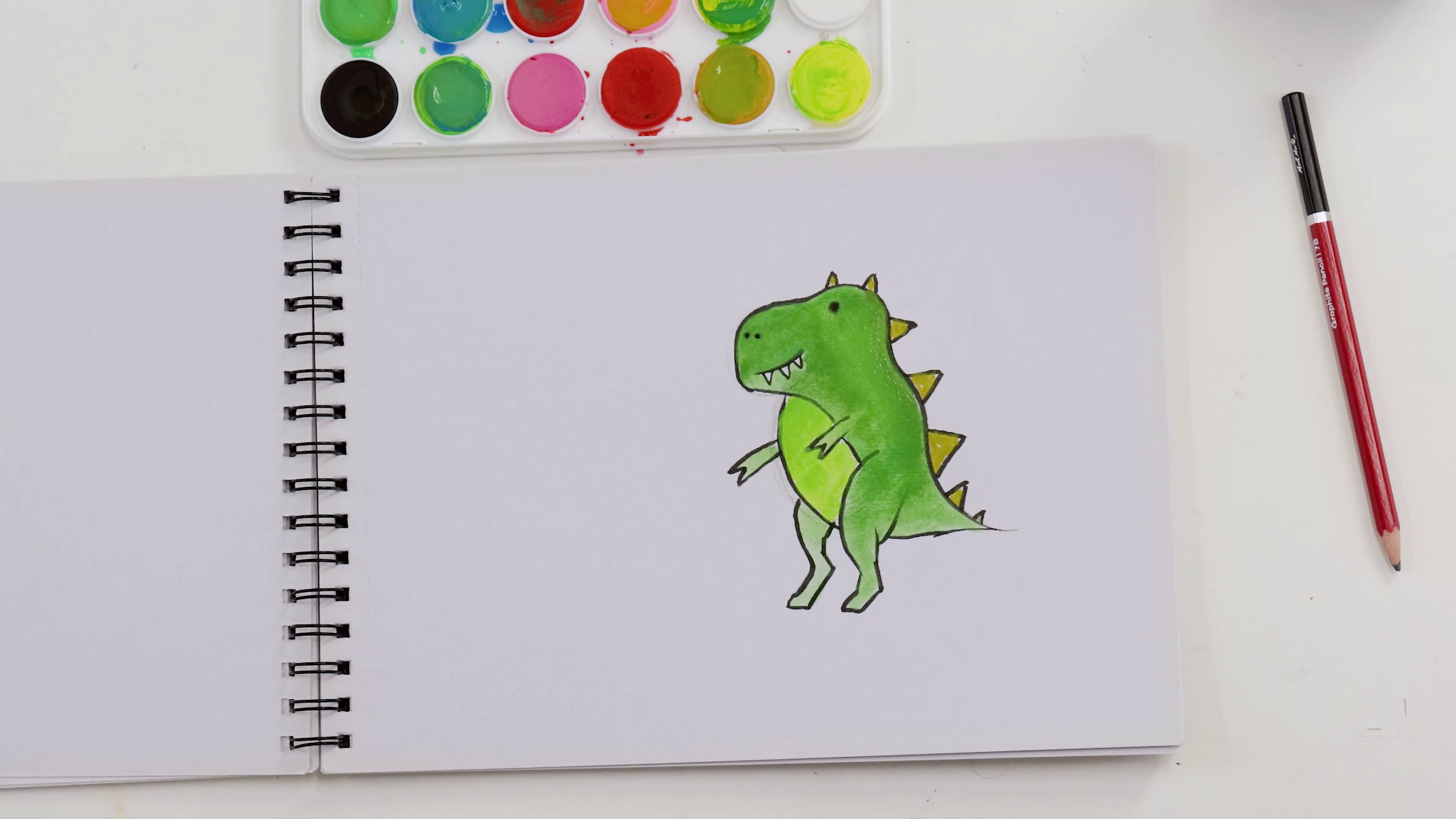 Green t-rex watercolour painting on sketchbook