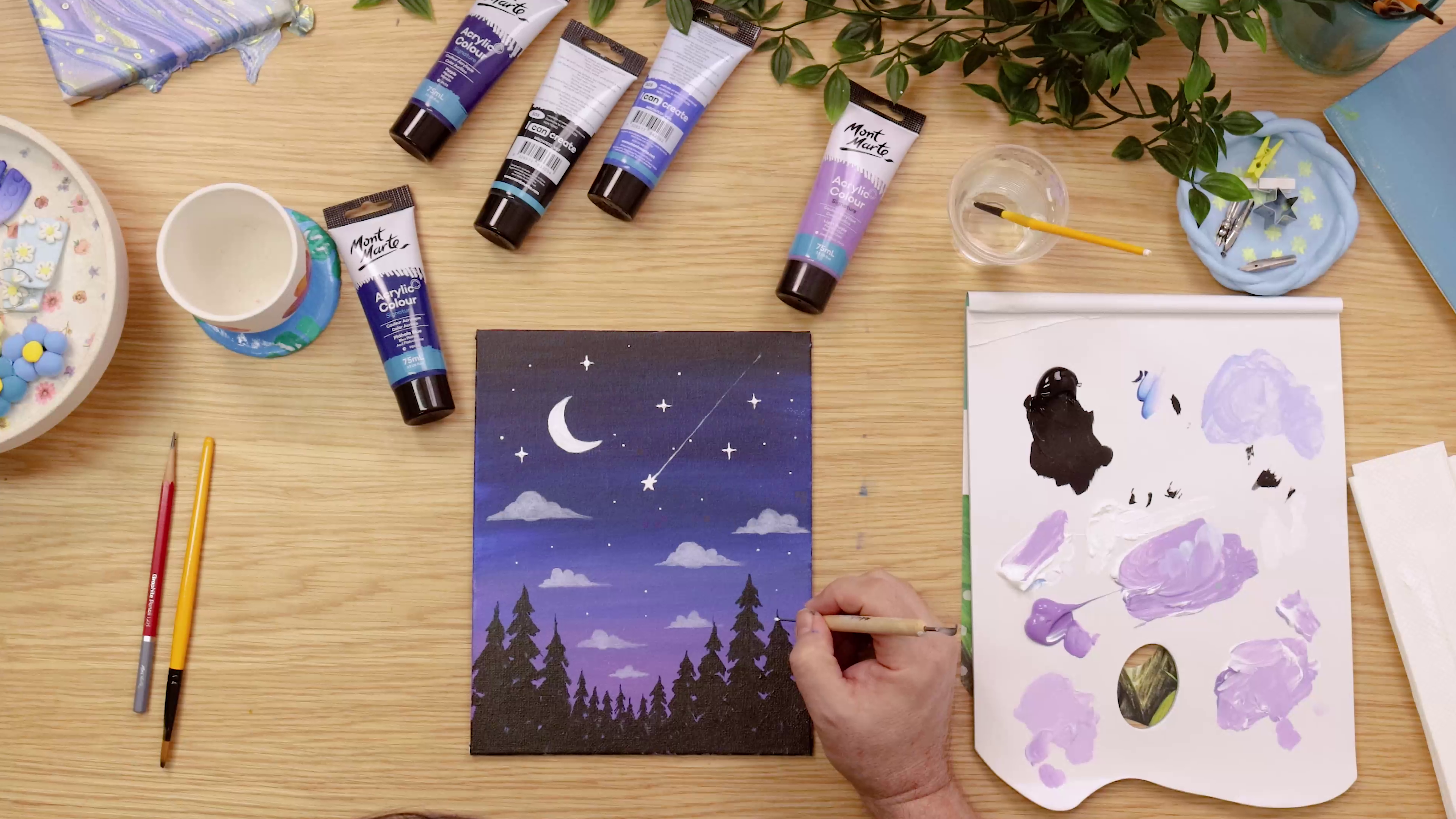 Painting highlights on trees in night sky painting