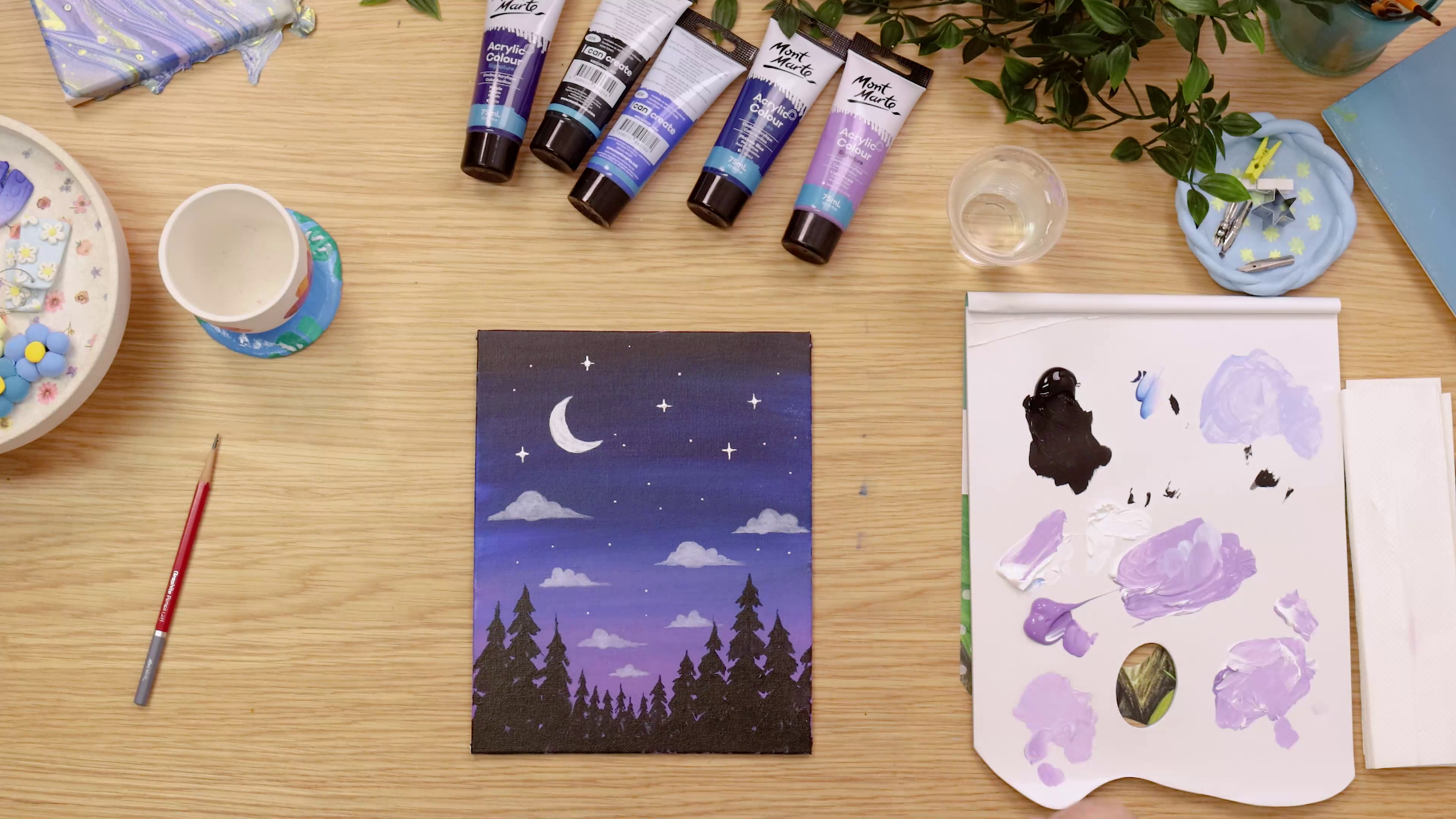 Night sky painting with stars on wooden table