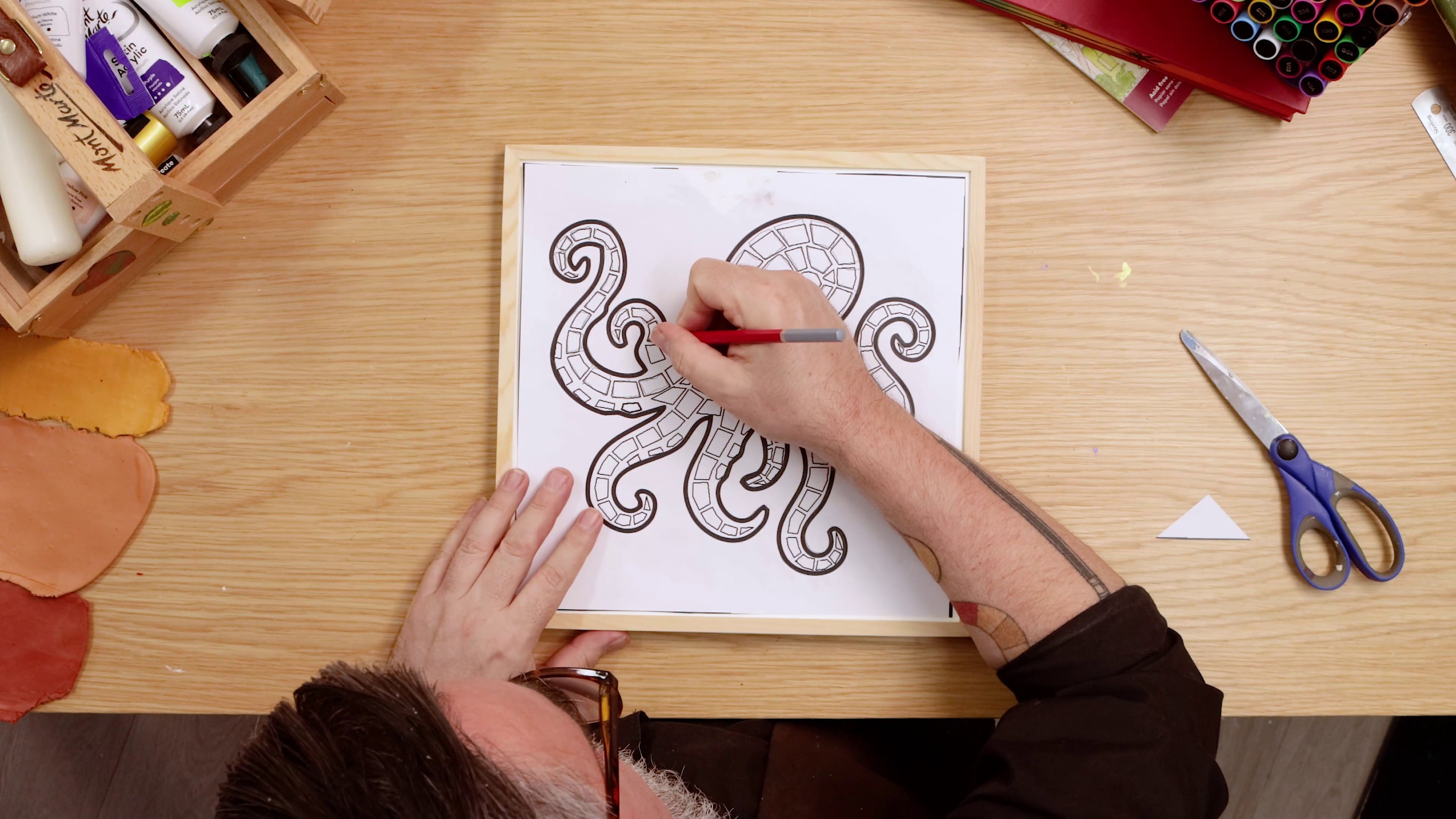 Tracing outline of octopus onto framed canvas