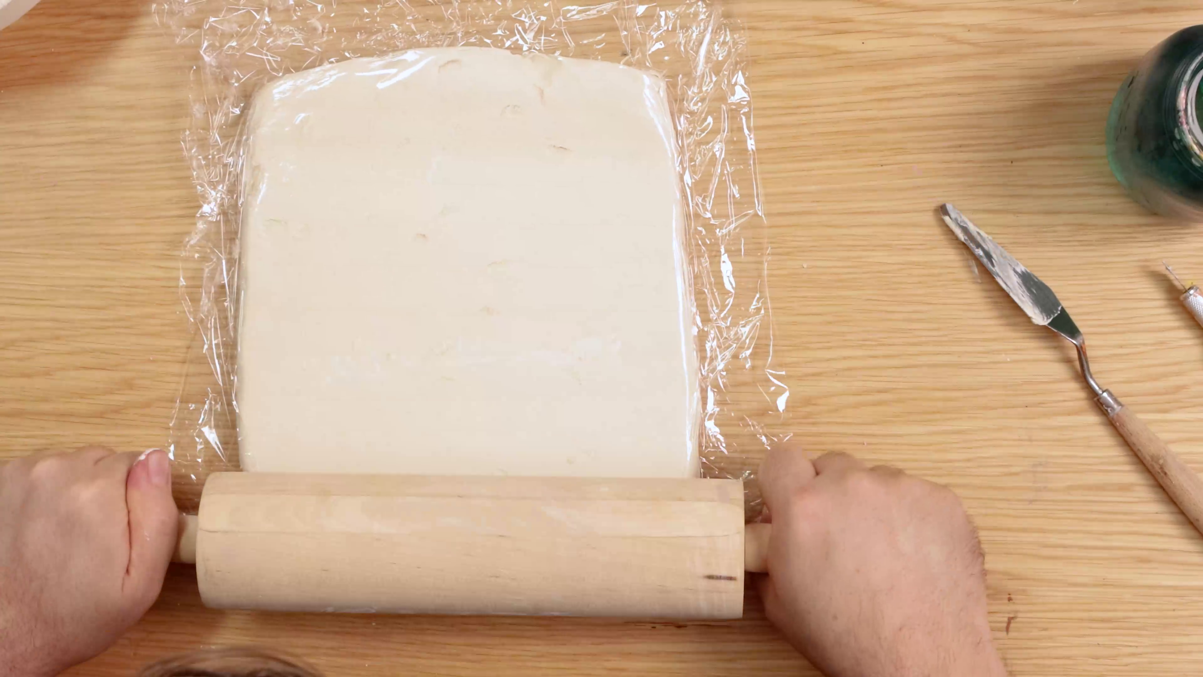 Rolling out air dry clay between cling film