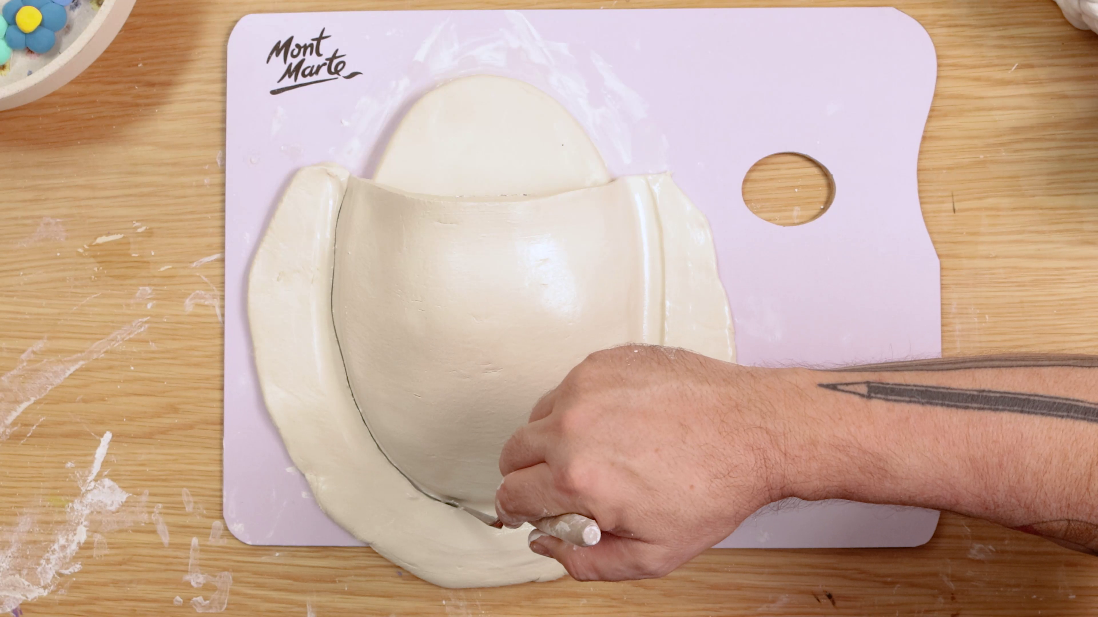 Cutting out oval shape air dry clay wall vase