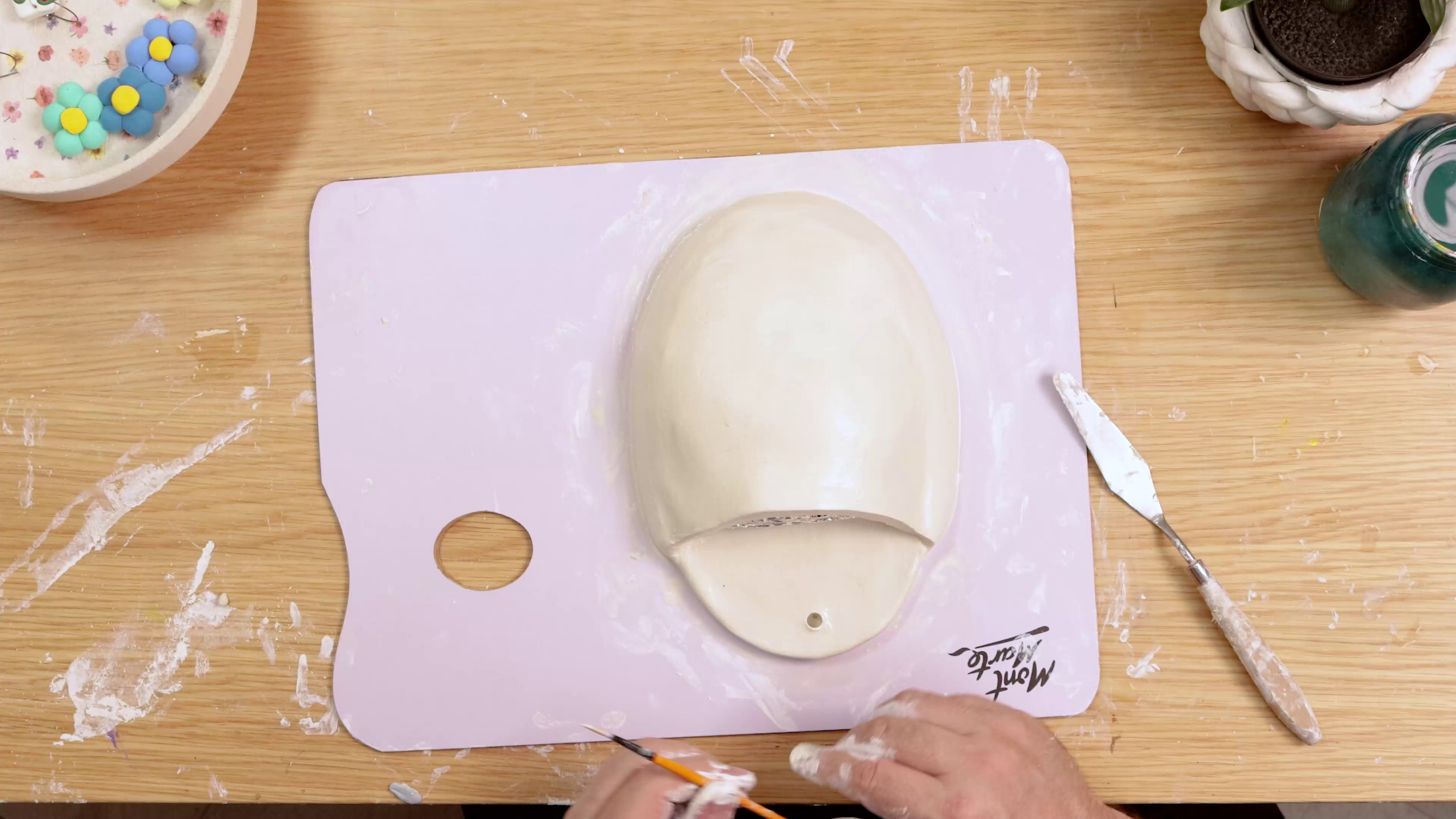 Hole poked in top of air dry clay wall vase