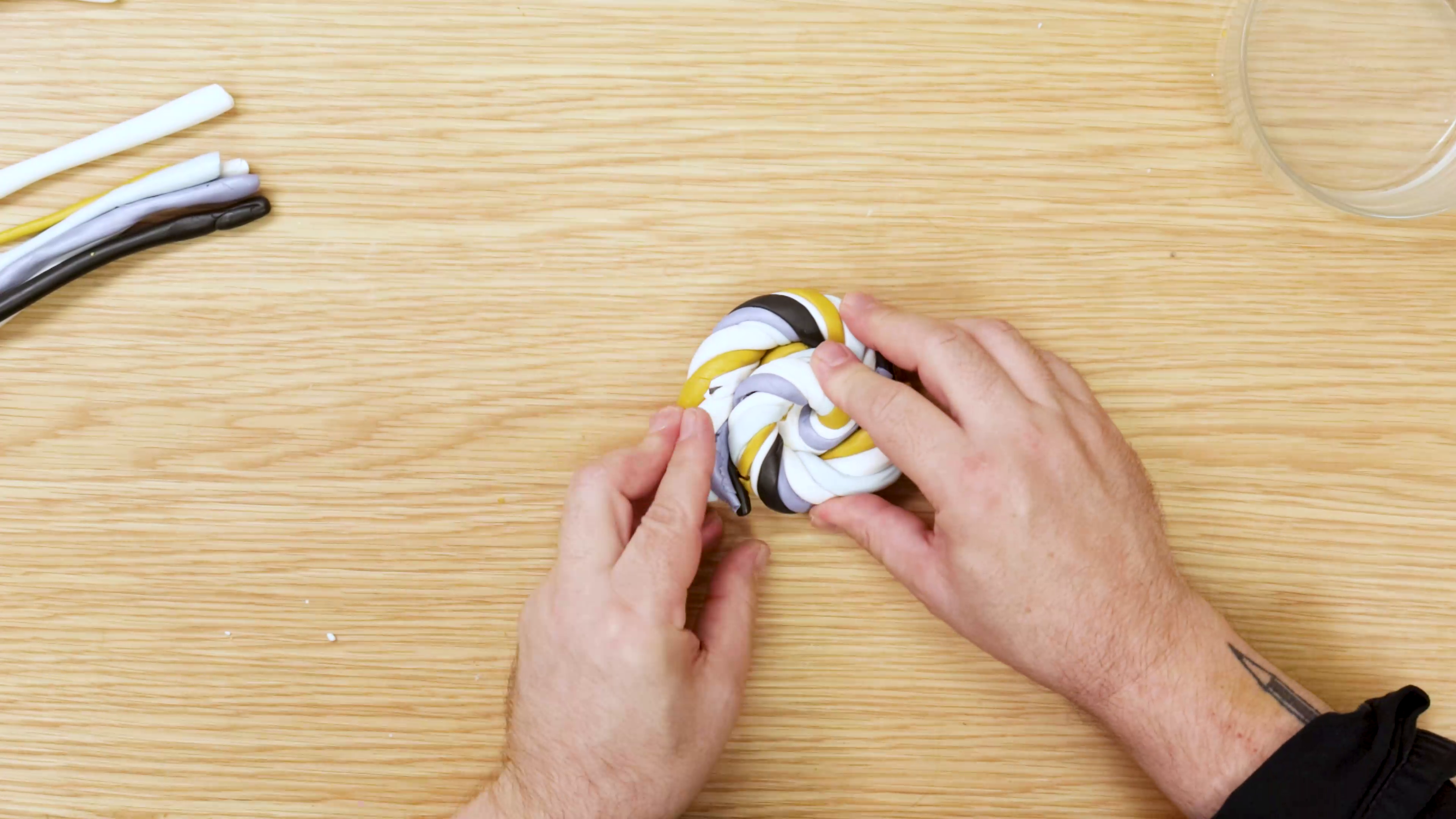 Curling twisted polymer clay tube into circle